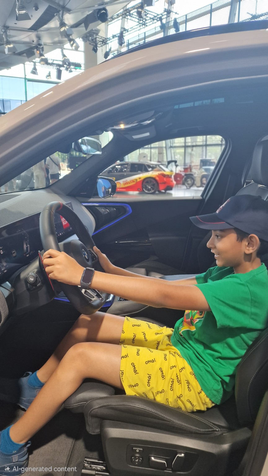 Dripto seated at the steering wheel of a stationary BMW display car.