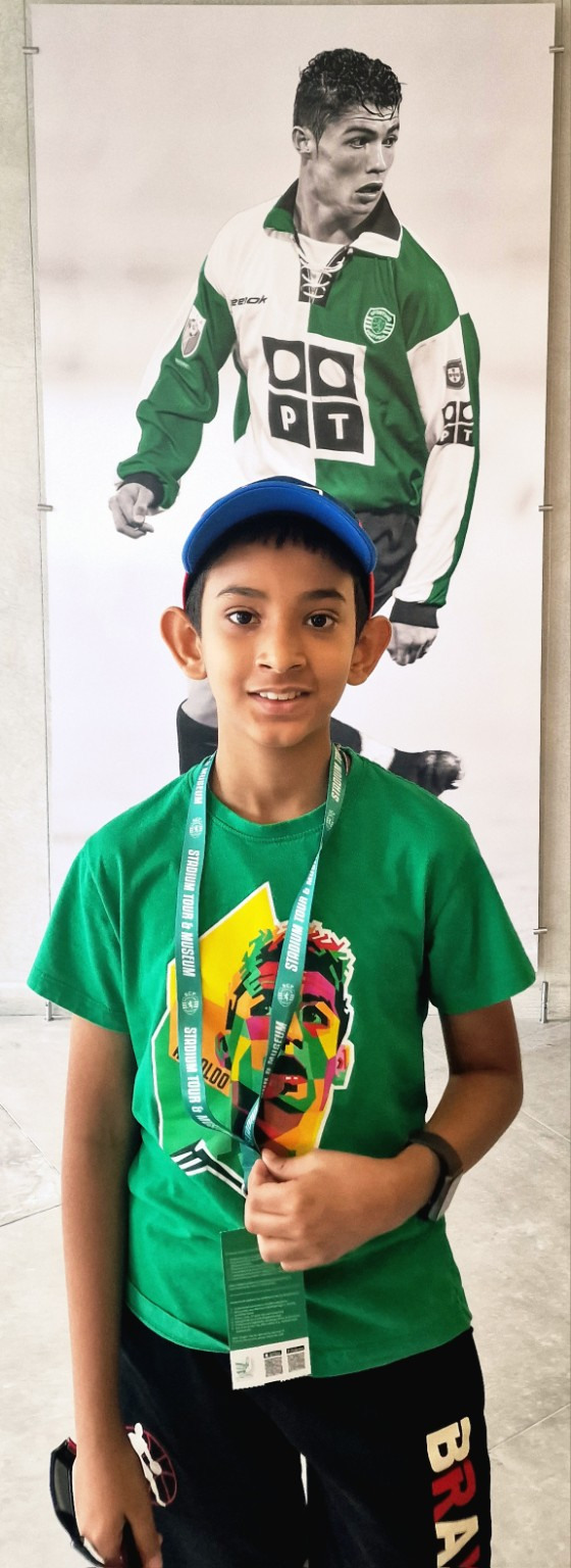 Dripto standing in front of a Cristiano Ronaldo exhibition image.